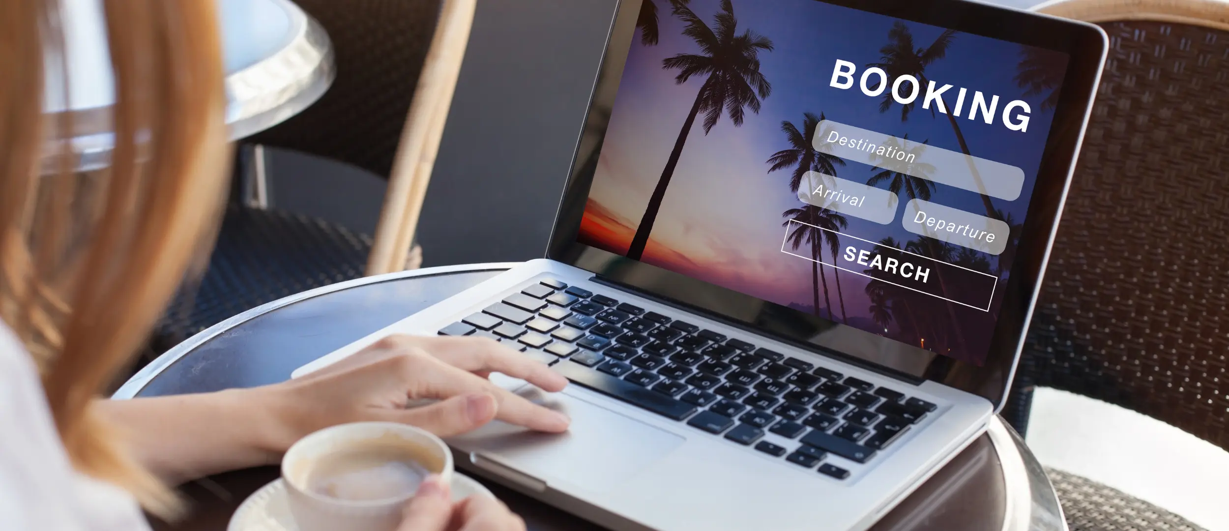 Person booking tropical vacation online using laptop with travel interface showing destination and dates